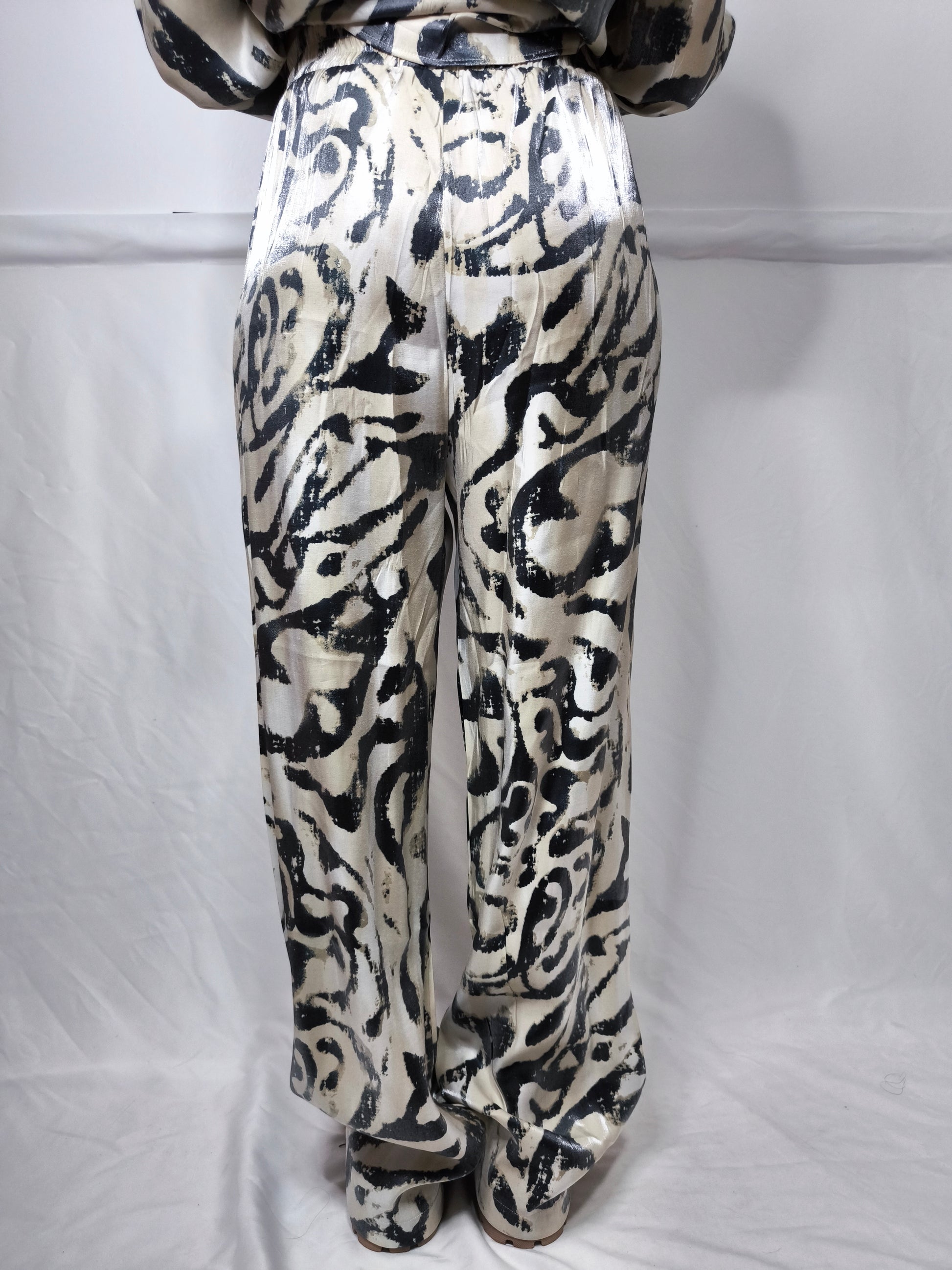 Completo donna con stampa astratta bicolore, composto da camicia a maniche lunghe e pantaloni ampi, ideale per un look moderno e confortevole.