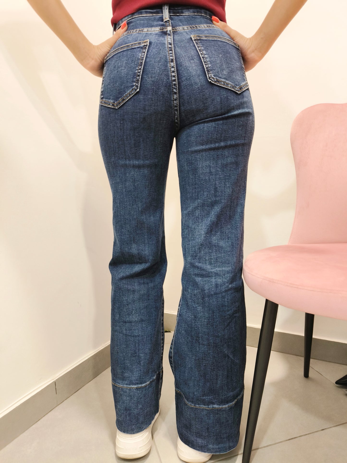 jeans donna a zampa in denim blu vita alta con sneakers bianche